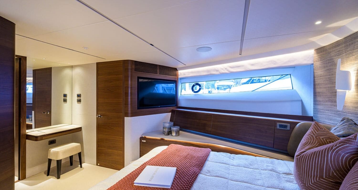 A serene view of the spacious bedroom on the 100' PRINCESS X95 yacht, designed for ultimate comfort.