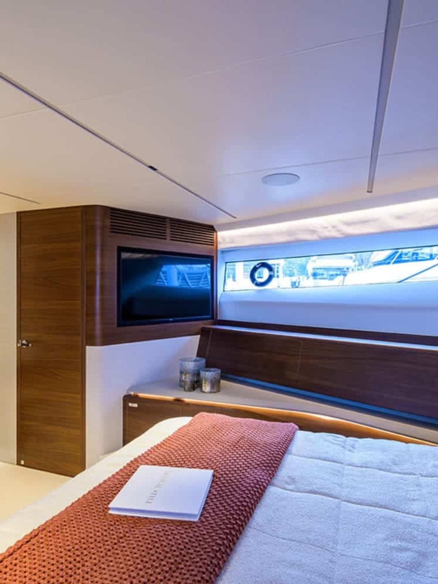 A serene view of the spacious bedroom on the 100' PRINCESS X95 yacht, designed for ultimate comfort.