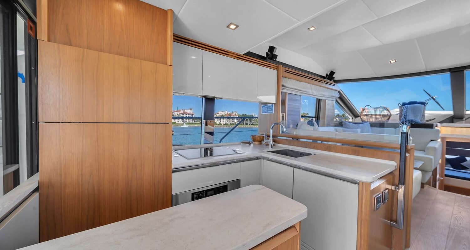 Modern kitchen onboard the 60' ABSOLUTE FLY yacht, featuring high-end appliances and a clean design.