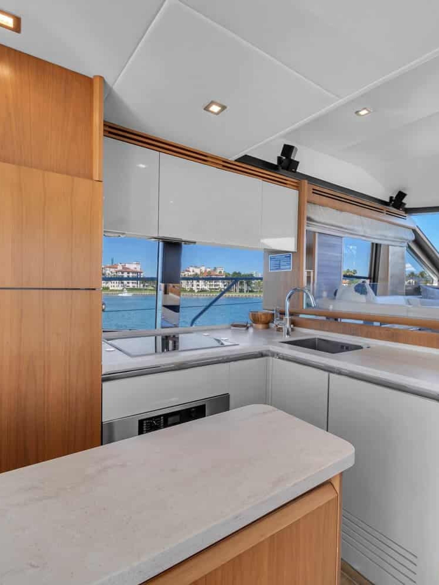 Modern kitchen onboard the 60' ABSOLUTE FLY yacht, featuring high-end appliances and a clean design.