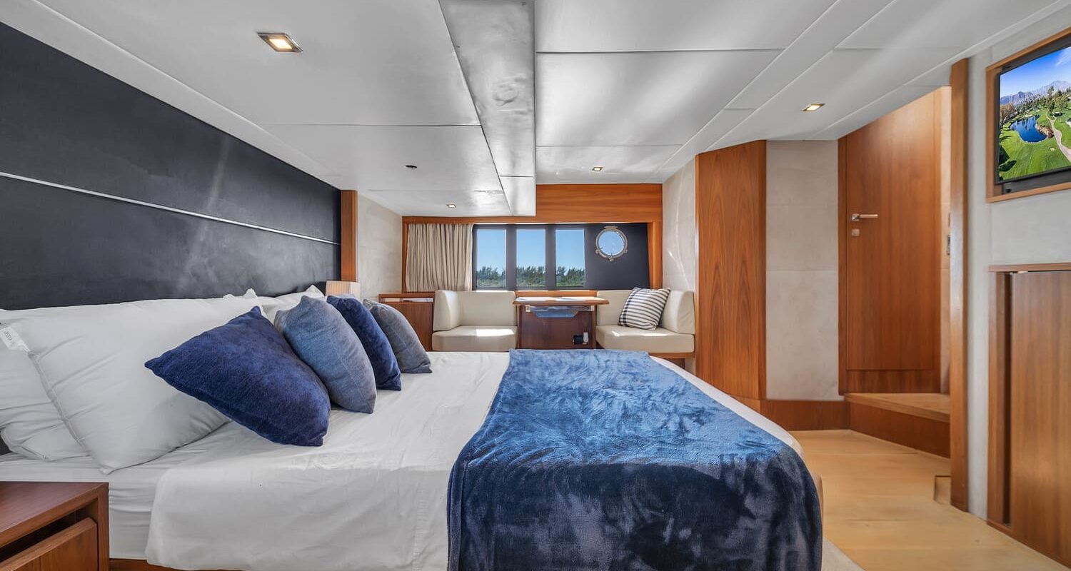 Another perspective of the luxurious bedroom aboard the 60' ABSOLUTE FLY yacht, showing a large bed.