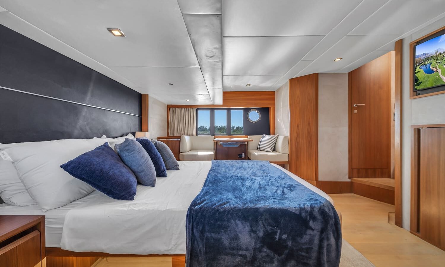 Another perspective of the luxurious bedroom aboard the 60' ABSOLUTE FLY yacht, showing a large bed.