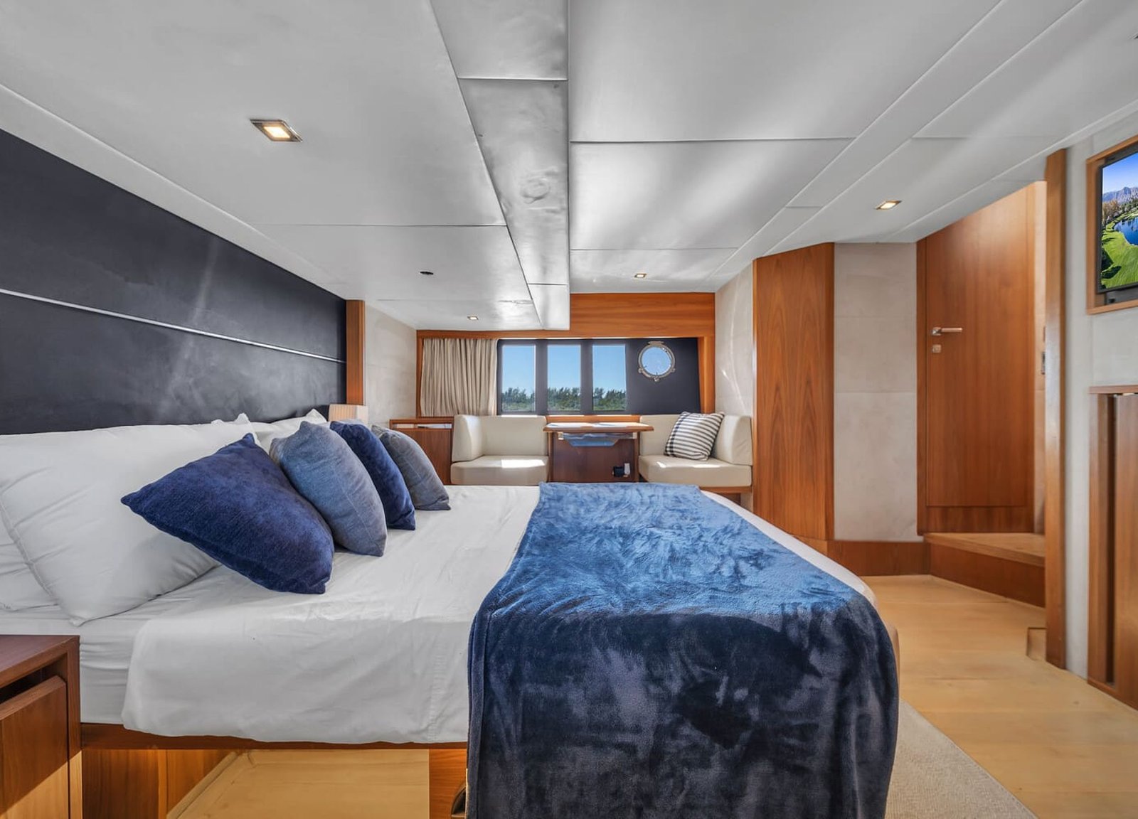 Another perspective of the luxurious bedroom aboard the 60' ABSOLUTE FLY yacht, showing a large bed.