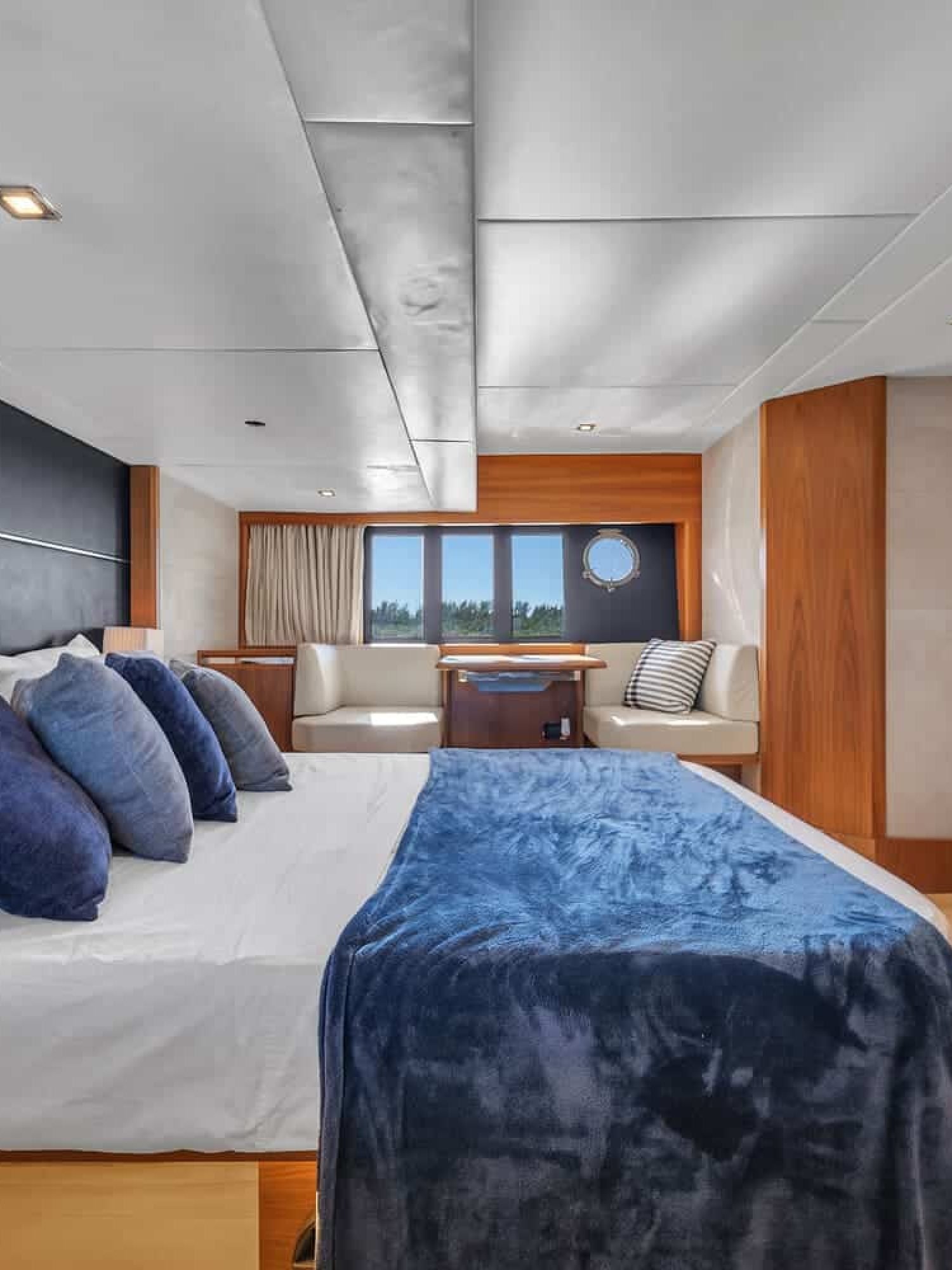 Another perspective of the luxurious bedroom aboard the 60' ABSOLUTE FLY yacht, showing a large bed.