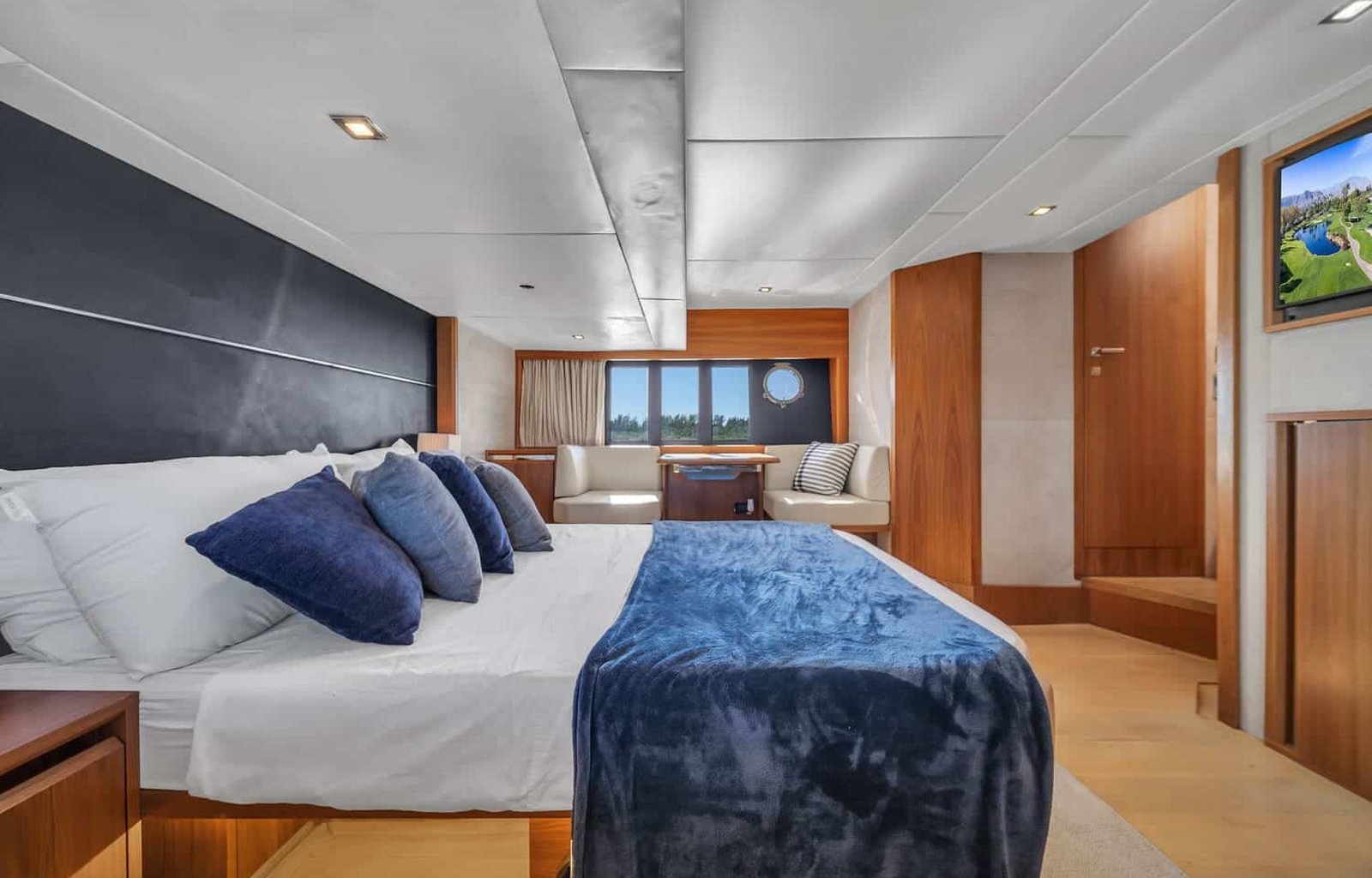 Another perspective of the luxurious bedroom aboard the 60' ABSOLUTE FLY yacht, showing a large bed.