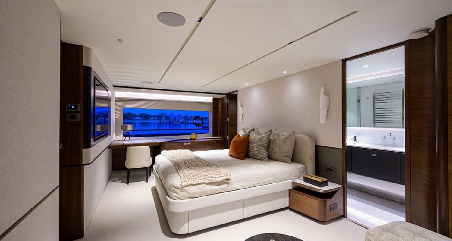 Elegant and comfortable bedroom on the 100' PRINCESS X95 yacht, offering a relaxing space at sea.